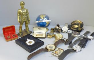 A collection of wristwatches including Michael Kors, a cast brass figure, a vesta case, paperweight,
