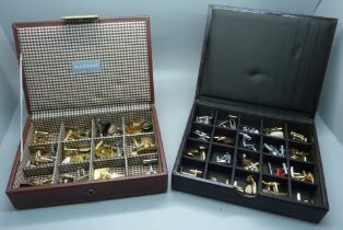 A collection of cufflinks, in two cases
