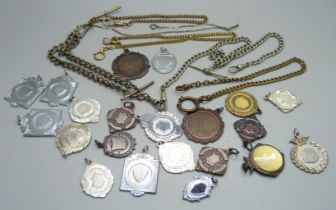 A collection of Albert pocket watch chains and fob medals