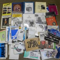 Three boxes of camera instruction booklets and camera auction catalogues