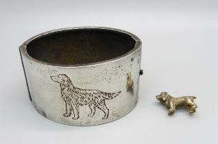 A wide hallmarked silver bangle engraved with red setter dog detail and a silver dog brooch,