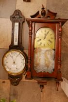 An Edward VII oak aneroid barometer and a mahogany wall clock