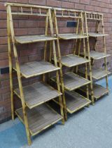 A set of three bamboo and rattan four tier folding whatnots