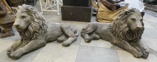 A pair of concrete garden figures of recumbent lions