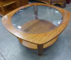 A teak and glass topped coffee table