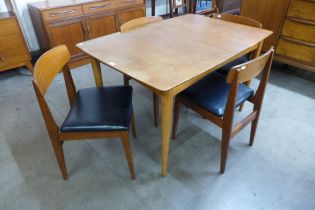 A teak extending dining table and four chairs