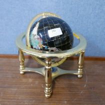 A small faux gemstone terrestrial globe on gilt metal stand