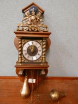 A Dutch mahogany and brass wall clock