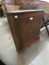 A mid 20th Century carved oak corner telephone cabinet