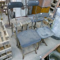 A set of four industrial machinist's chairs