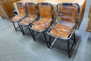 A set of four Les Arc style black tubular metal and brown leather ski chalet chairs, after Charlotte