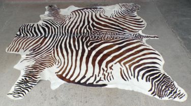 A zebra pattern cow hide rug