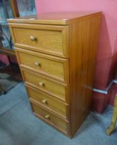 A G-Plan teak chest of drawers and a teak and tiled top two tier trolley