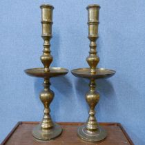 A pair of large Indian brass candlesticks