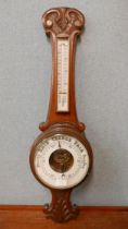 An Edward VII carved oak aneroid barometer
