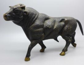A bronze cold painted model of a bull, length 24.5cm