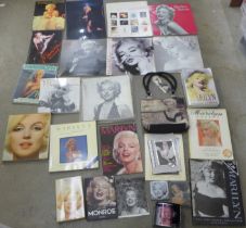 A box of paperback books on Marilyn Monroe and other Marilyn Monroe items including a mug,