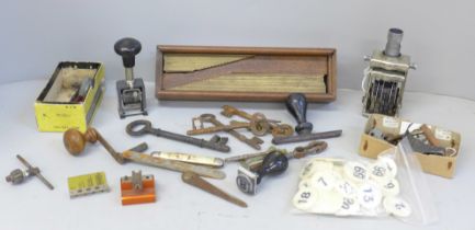 Antique door keys, desk stamps, watch tools, etc., and a cased set of brass typesetting rules