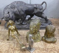 A cast iron bull, 35cm wide, a car mascot type figure and three other figures