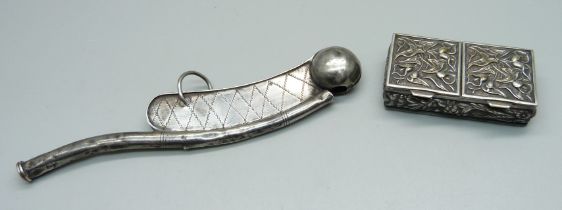 A silver bosun's whistle, circa 1880, and a white metal box with foliate design, whistle dented