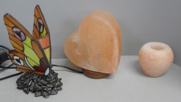 A Himalayan salt candlestick holder, a heart shape table lamp and a butterfly lamp