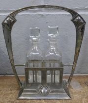 An Art Nouveau two bottle oil and vinegar cruet, electroplated base stamped no. 444/2 with WMF