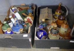 Two boxes of whisky decanters, mostly Bells, and a bottle of Dimple Whisky, some with contents