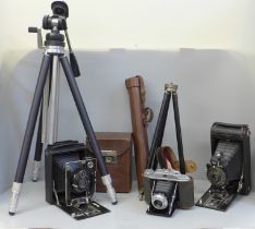 A Kershaw 630 camera, a Kodak folding camera, two tripods, etc.