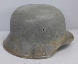 A German M42 helmet, inner leather replaced