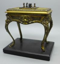 A cast metal table vesta in the form of French Louis XI style table with chessboard and chess pieces