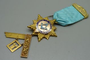 A 15ct gold and enamel Masonic medal on a gilt metal (not gold) mounted blue ribbon, total weight
