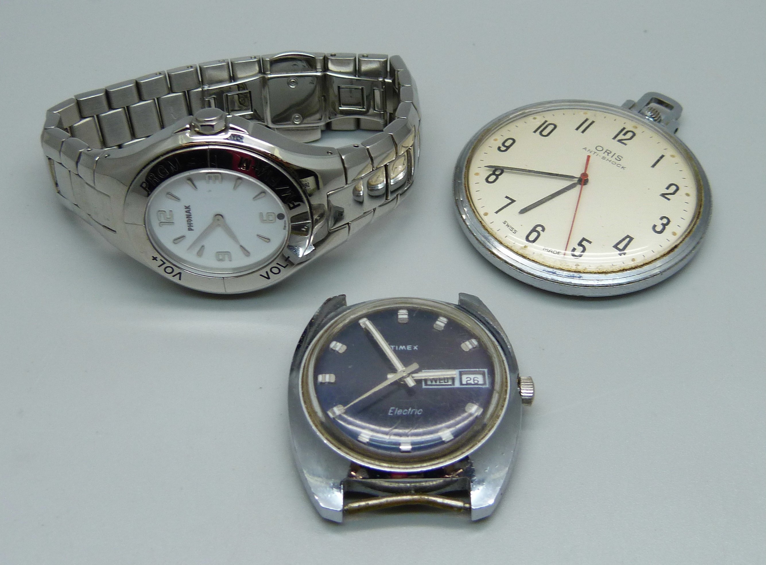An Oris pocket watch, a Timex Electric wristwatch with day/date and a Phonak Hearing Systems