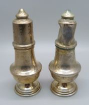 A silver salt and pepper pair, salt a/f, silver approximately 68g