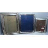 A silver photograph frame, a/f, and two silver plated photograph frames