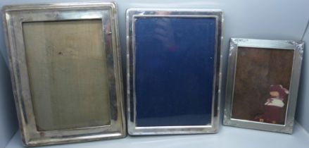 A silver photograph frame, a/f, and two silver plated photograph frames
