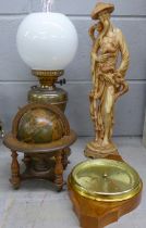 A barometer, an oil lamp, a figure and a globe **PLEASE NOTE THIS LOT IS NOT ELIGIBLE FOR POSTING