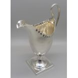 A George III silver helmet shaped jug, London 1810, 95g, with initials