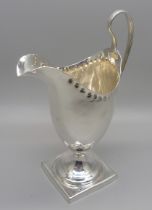 A George III silver helmet shaped jug, London 1810, 95g, with initials