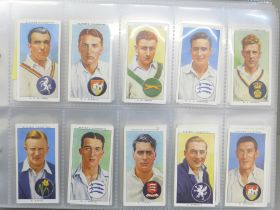 Cigarette cards; an album of Players cigarete cards, ten sets including cricketers, 1930, 1934,