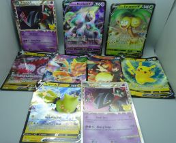 Nine large Pokemon cards including Charizard and Pikachu