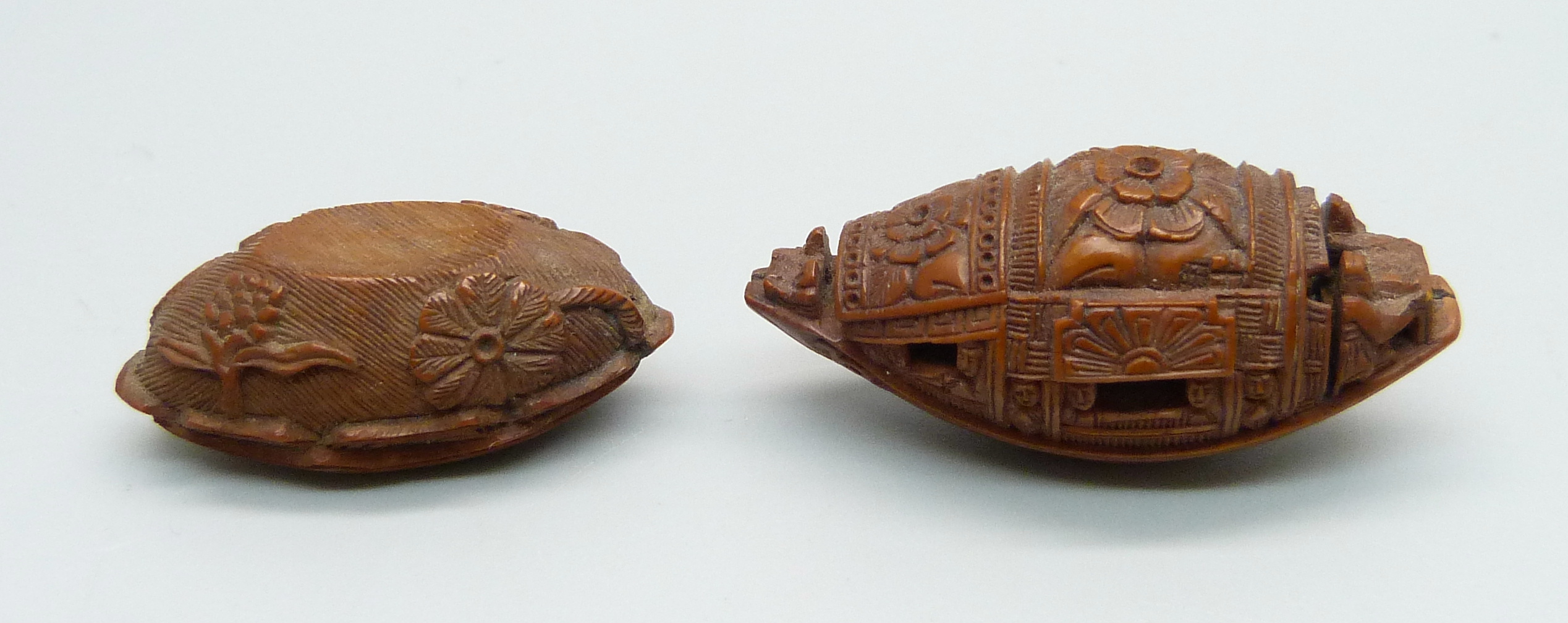Two carved hediao nuts, one in the form of a Sampan boat with Chinese script