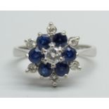 An 18ct white gold, diamond and sapphire ring, central round brilliant cut diamond and six mixed-cut