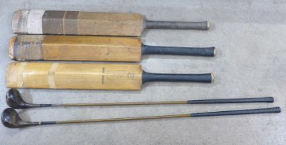 Three 1920s cricket bats, Gunn & Moore, Wisden's and Duke & Son, and two golf clubs, driver and