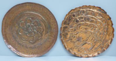 Two embossed copper Arts and Crafts dishes, 22.5cm and 24.5cm