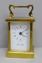 A brass and four glass sided carriage clock with long service inscription, boxed