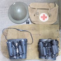 A helmet, kit bag, Red Cross canvas bag and two pairs of binoculars inculding Zenith Tempest 10x50mm