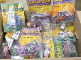 A collection of Rally Car magazines, with model vehicles, over sixty issues