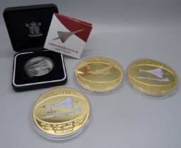 A Royal Mint Solomon Islands $25 silver proof coin, Concorde, boxed, and three Concorde gold