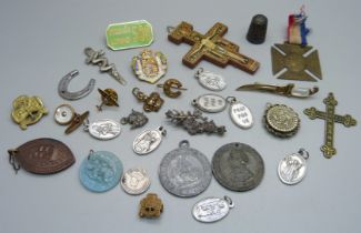 A collection of medallions, badges, cross pendant, etc.