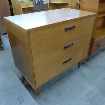 A teak chest of three drawers